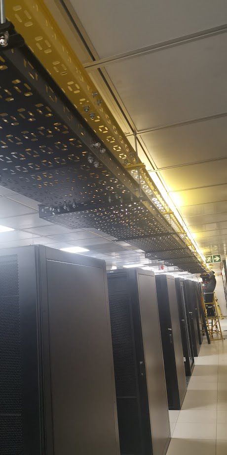 Data centre hall aisle with overhead cable containment